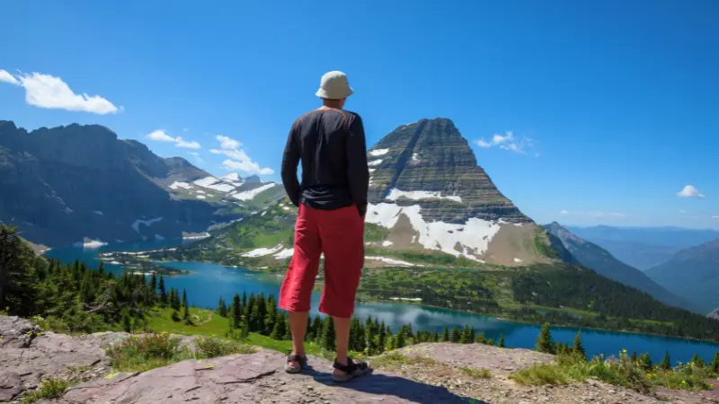A hiker admires Banff's breathtaking mountain and lake views.