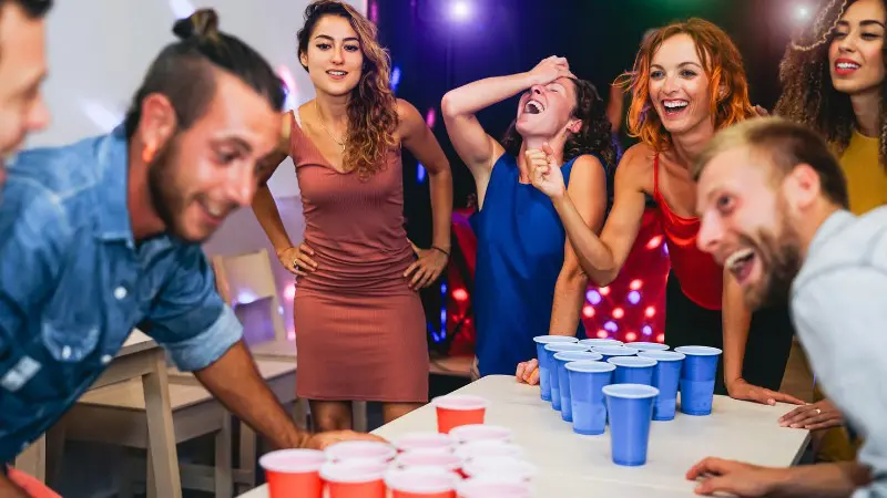 Group of friends playing games in a lively Nicosia bar at night.