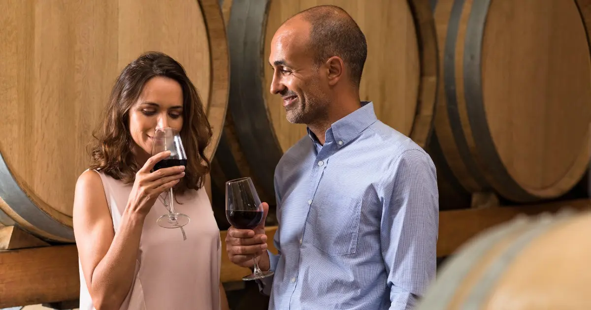 Guests enjoying a wine tasting in Adelaide Hills, with a sommelier serving wine.
