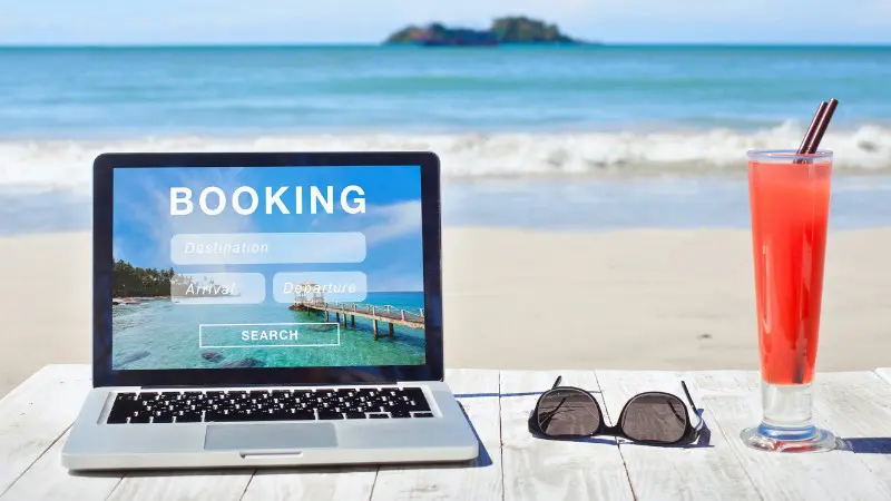 Booking flights with reward miles while relaxing on the beach.