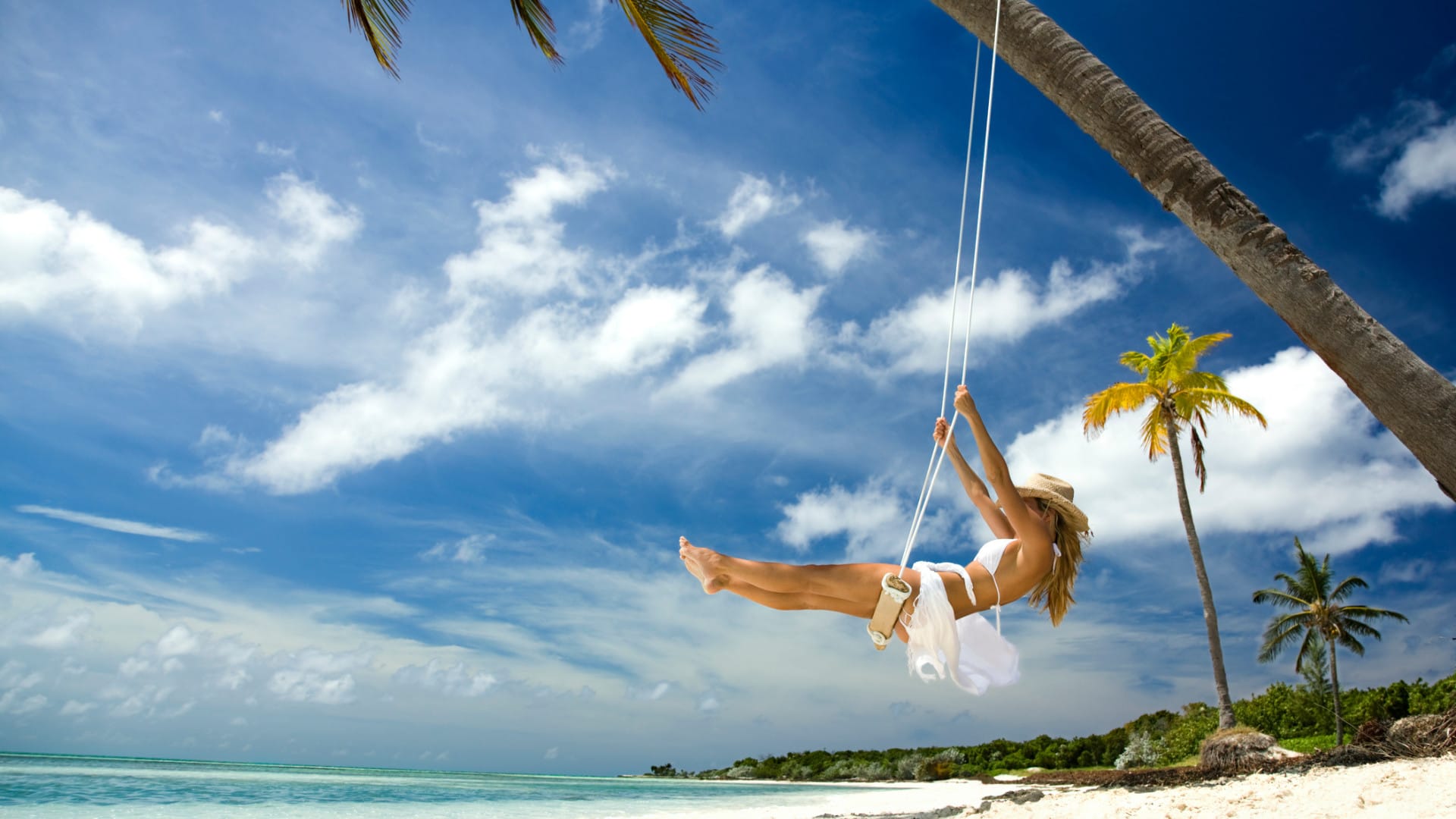 Image of woman using tree swing in the bahamas
