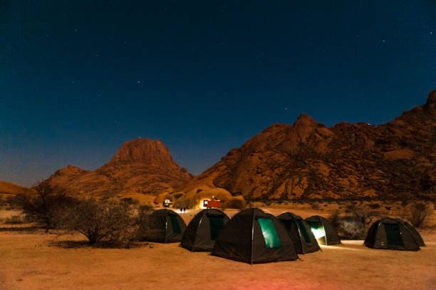 Image of people camping in desert