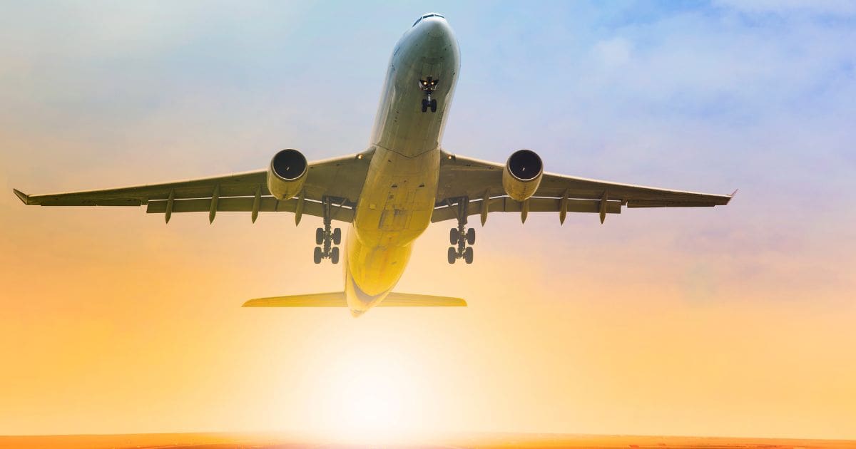 Maximize travel rewards - Airplane and sunrise