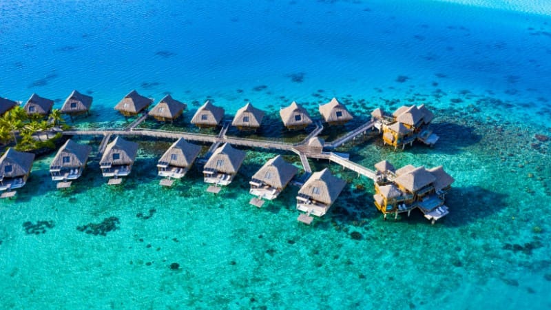 Luxury overwater bungalows at an adults-only resort in Fiji, offering breathtaking views of the turquoise lagoon.