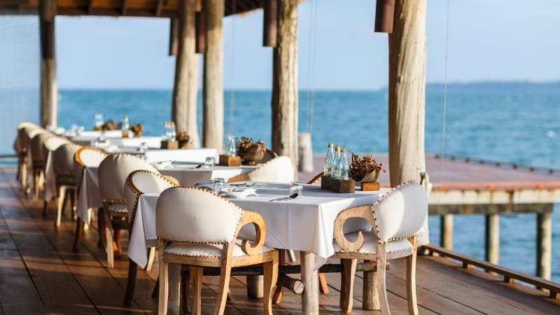 Oceanfront dining table at a resort, one of the top experiences highlighted in our complete Eleuthera travel guide.