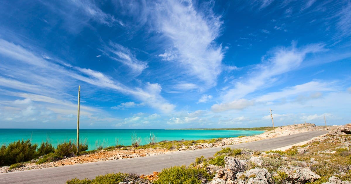 Traveler's complete guide To Eleuthera - A stunning beach with turquoise waters and clouds.