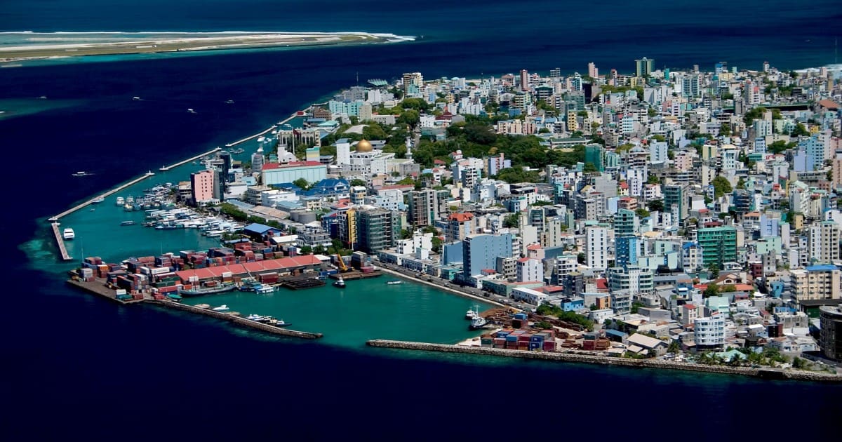 Male travel guide - Aerial view of colorful buildings and bustling port in Male, Maldives.