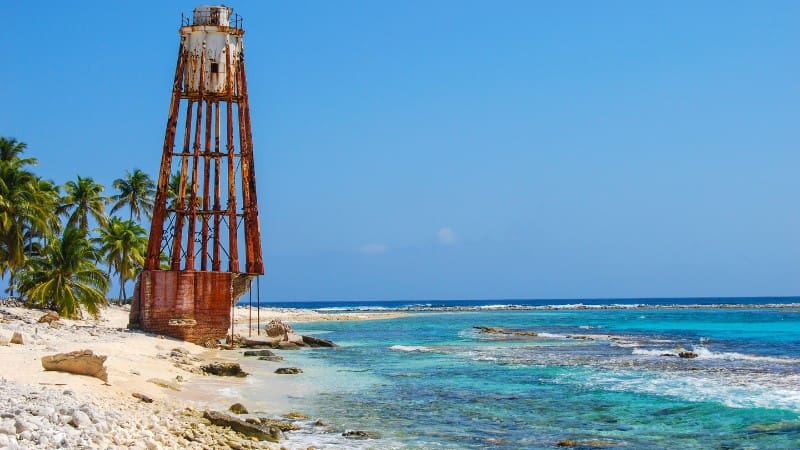 Rustic lighthouse near the vibrant Lighthouse Reef Atoll by the Great Blue Hole.