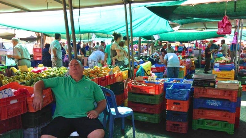Shoppers browse fresh produce at the bustling OHI Farmer's Market, a popular activity in Nicosia.
