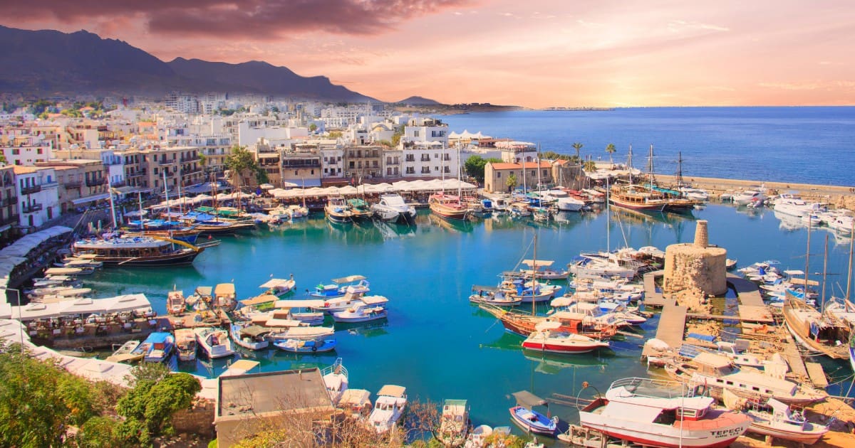 Things to do in Nicosia - Boats are docked at the beautiful Kyrenia Harbor with a stunning sunset.