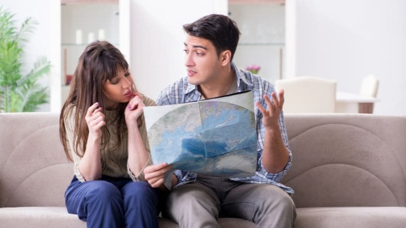Couple planning their trip, discussing the best time to visit Panama based on their interests and preferences.