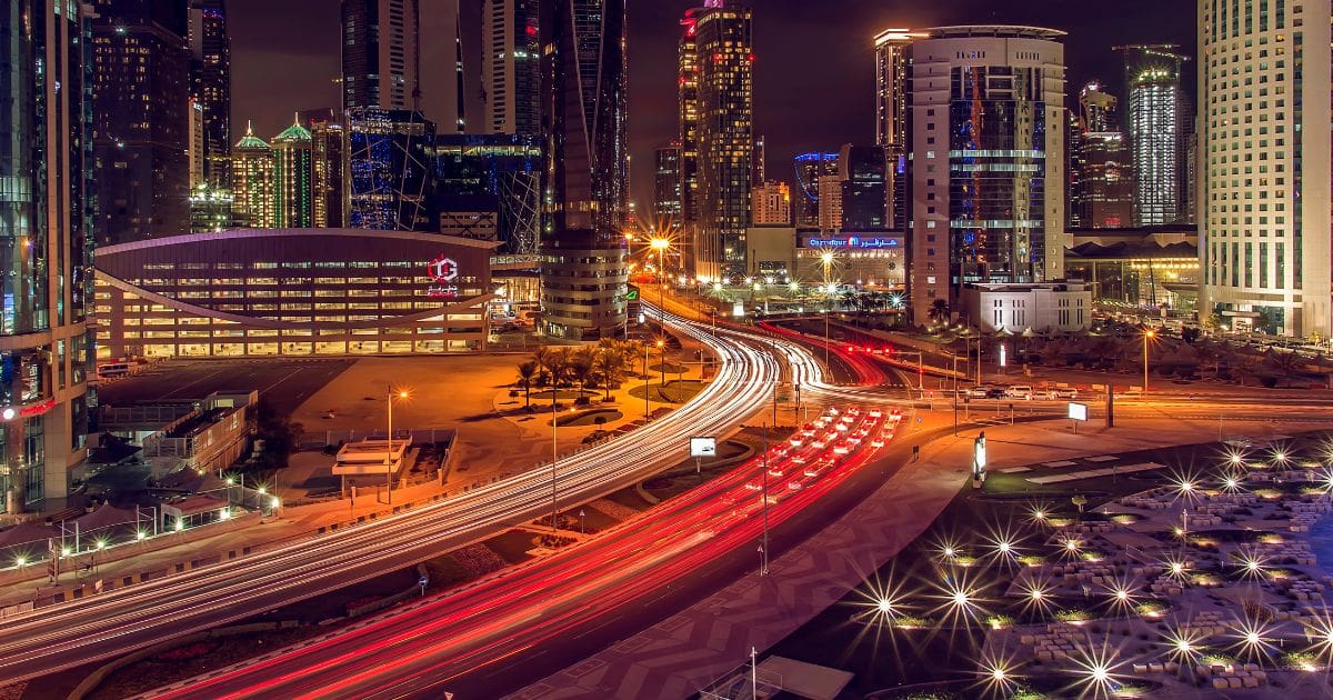 Busy streets and highways at night, showcasing transportation options for getting around Doha.