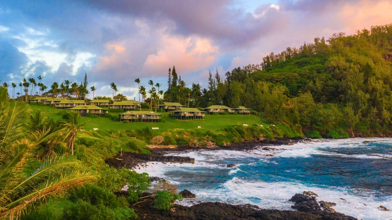 Oceanfront villas at adults-only Travaasa Hana with lush scenery.