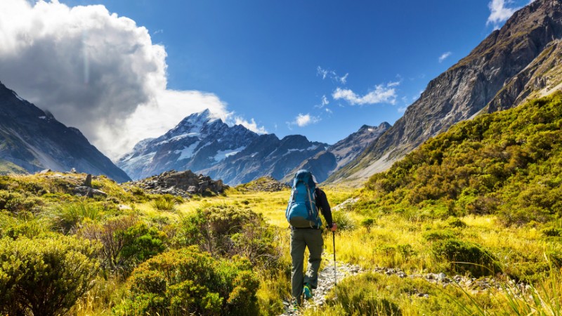 Hiker explores New Zealand's mountain trails and scenery.