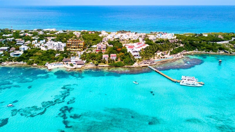 A picturesque aerial view of the coastal area at Playa Mujeres with clear blue waters.