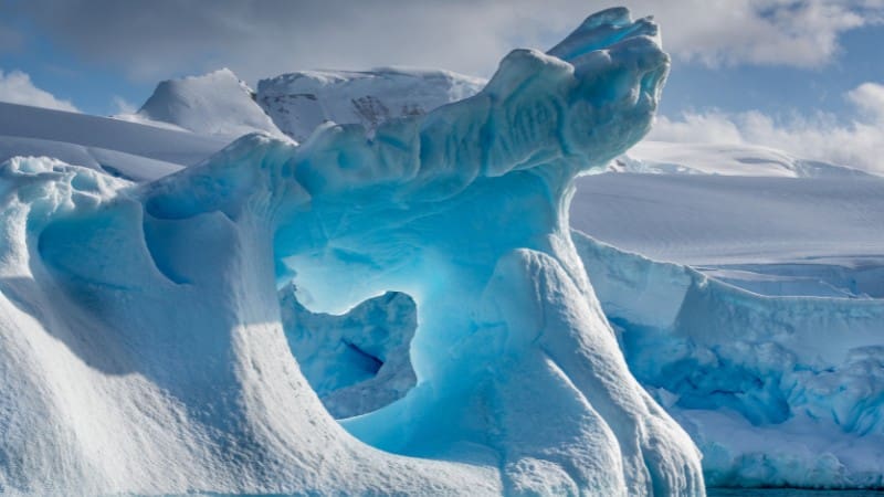 Learn how to get to Antarctica to witness breathtaking glowing ice formations in person.