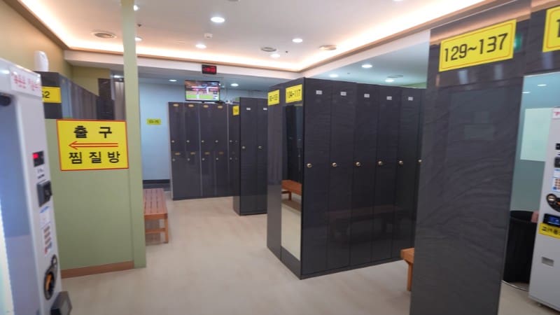 Spacious locker room inside a Korean sauna with neatly organized numbered lockers.
