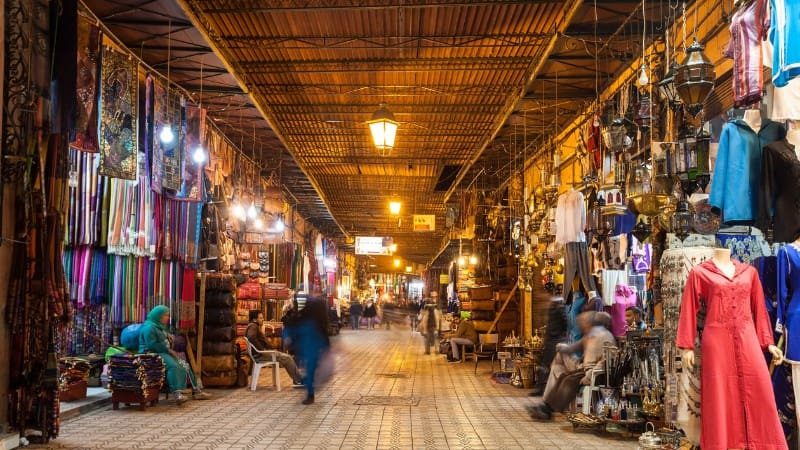 Visit a night market with colorful crafts, a must-do in Marrakech.