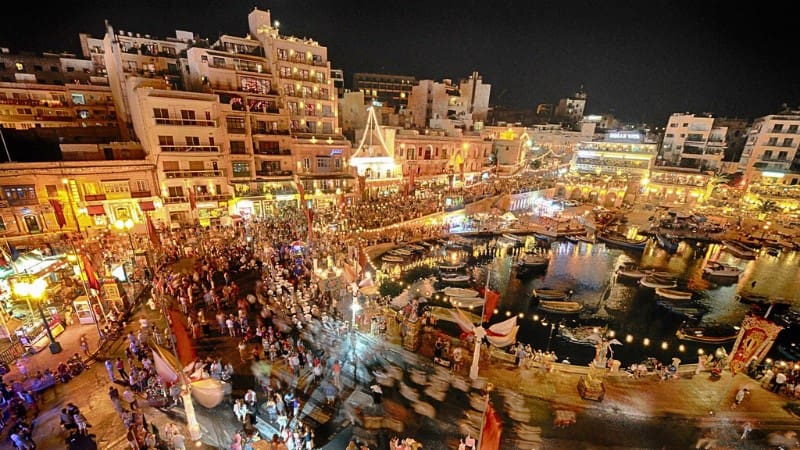 Valletta's lively waterfront area comes alive at night with entertainment and crowds.