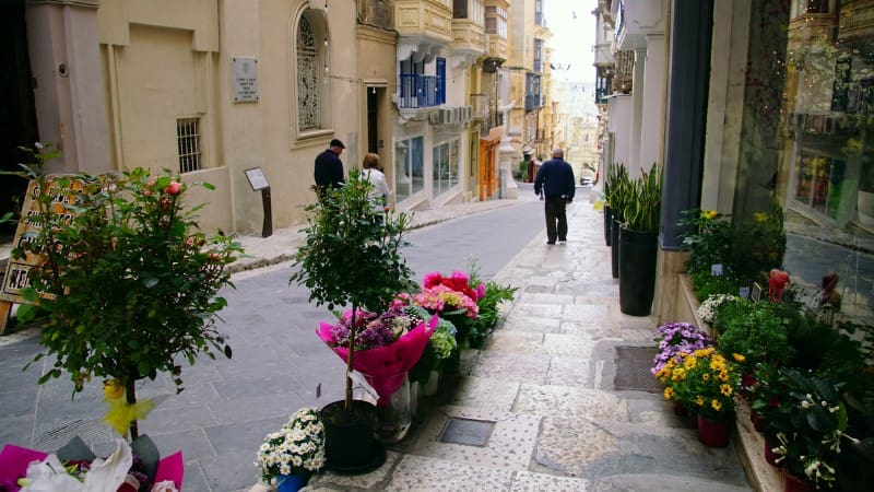 Explore flower-filled streets of Valletta, a must-do activity when visiting Malta's capital.