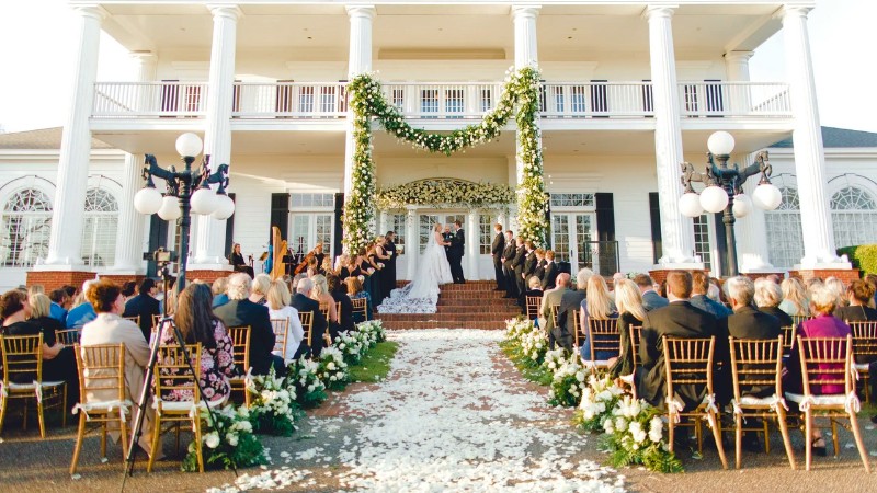 Grand Southern mansion wedding ceremony in Alabama with floral entrance.