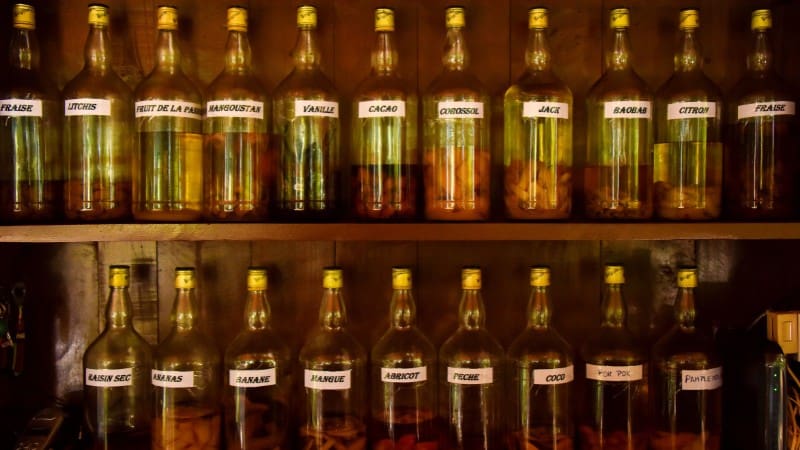 Artisanal Belizean fruit liqueurs in bottles, with tropical flavors as unique souvenirs.