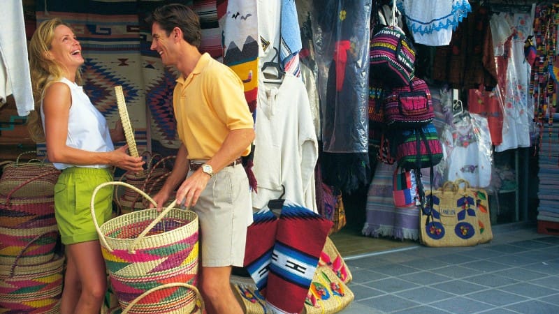 Belize souvenirs market with colorful baskets and textiles.