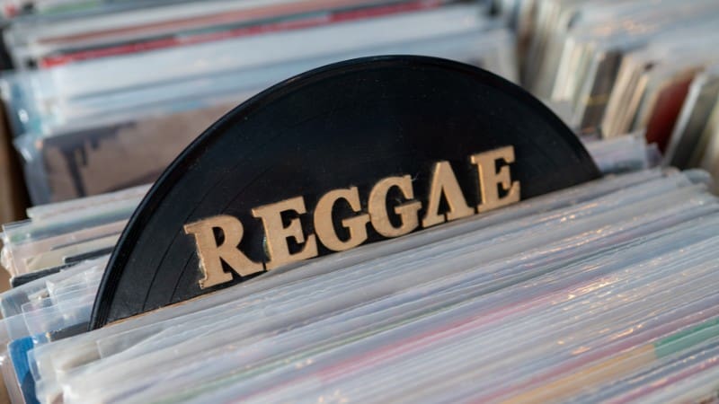 Reggae vinyl record among albums, popular Caribbean music souvenir.