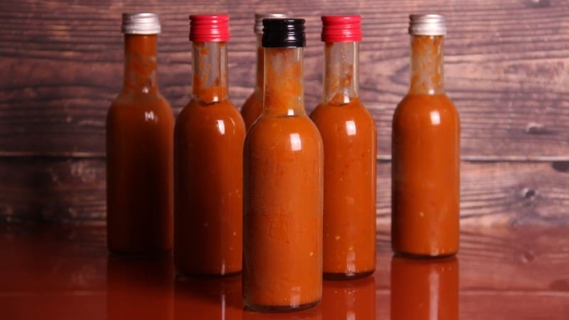 Homemade Belizean hot sauce bottles, a spicy souvenir representing local cuisine.